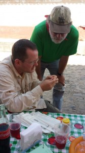 Dr. Clint Whipple, Assistant Professor at Brigham Young University and Dr. Cliff Weil, Professor at Purdue University look for lodicule (a floral organ) phenotypes in maize spikelets over lunch at José’s taco stand. 