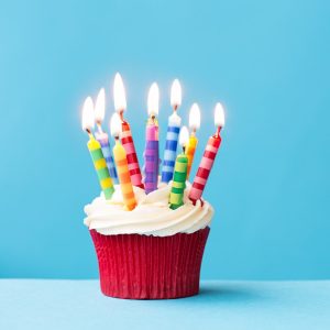 A cupcake with birthday candles