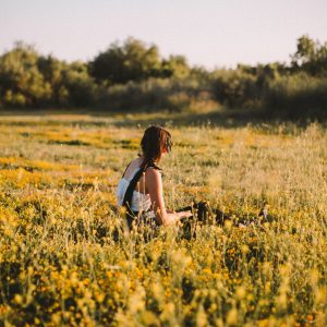 Someone sitting in a field