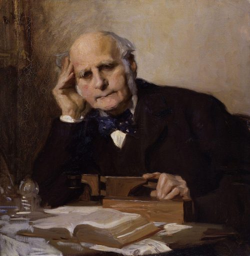 Painting of Francis Galton sat at a desk with open books