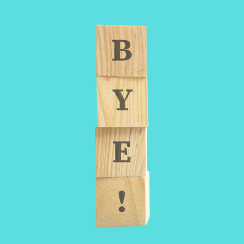 Stacked wooden cubes spelling out "BYE!"