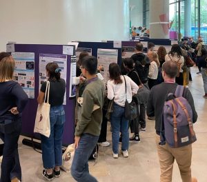 Conference attendees discussing during poster session at 2023 YEN conference. 